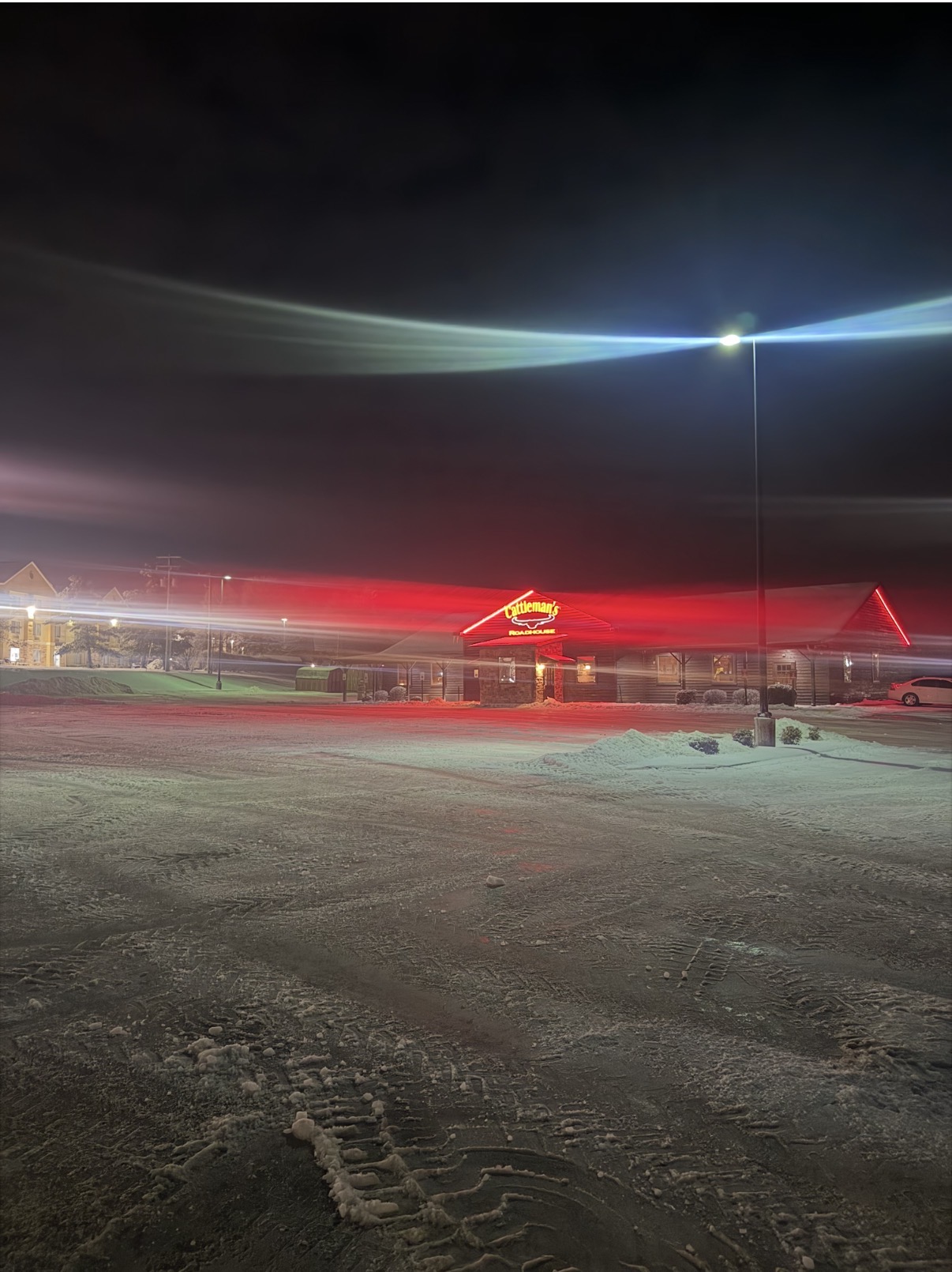 Snow removal in the Cattleman’s parking lot at night