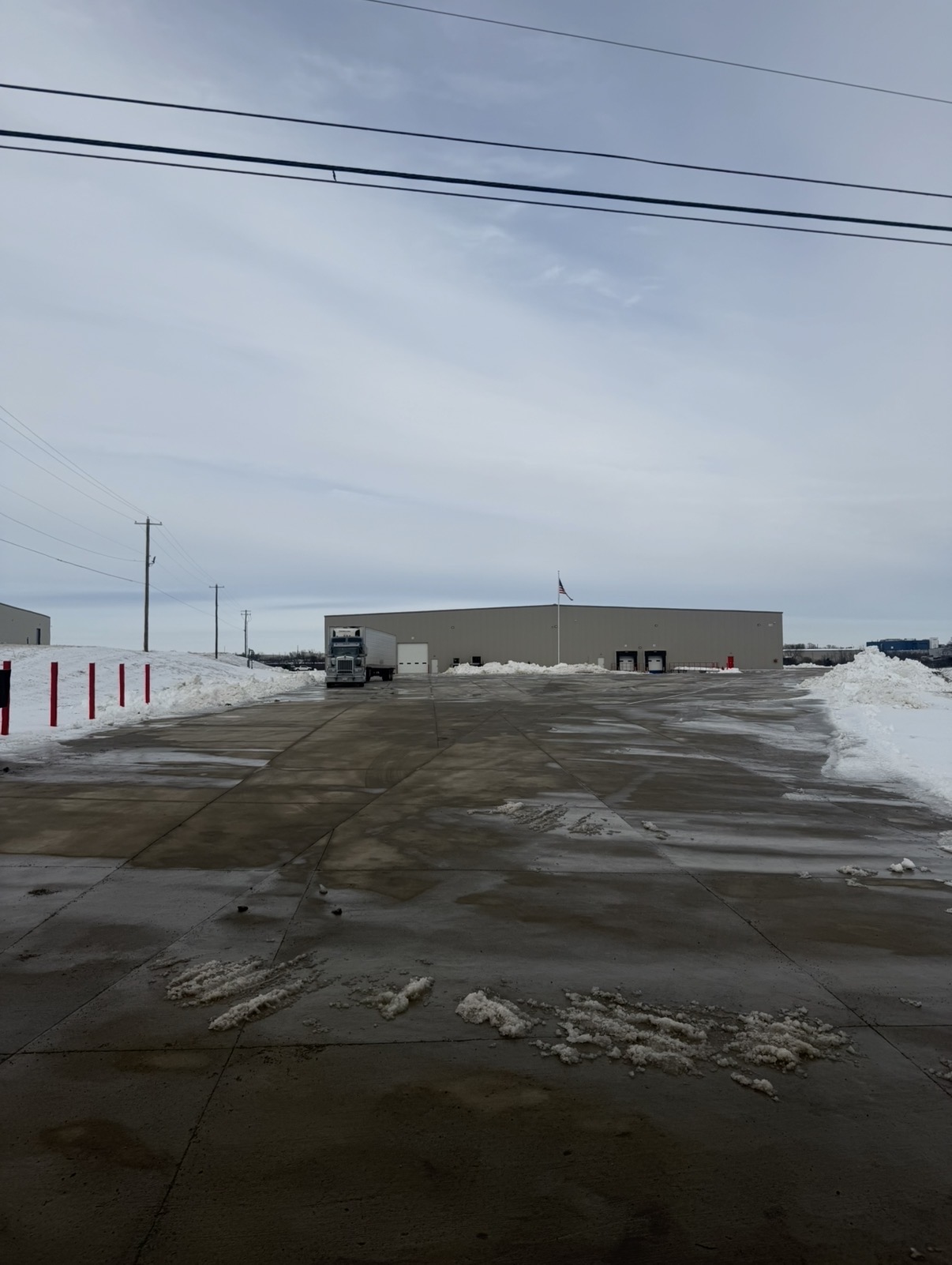 Cleared warehouse lot with snow along both sides